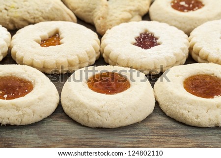 rows of fruit jelly biscuit cookies on painted wood background