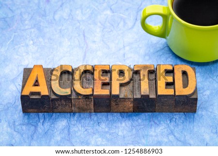 accepted - word abstract in vintage letterpress wood type with a cup of coffee