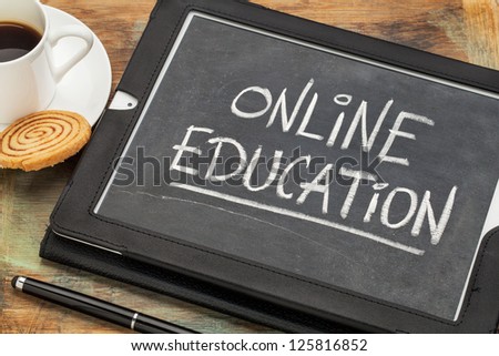 online education concept - white chalk handwriting on old slate blackboard displayed on a screen of digital tablet computer together with a cup of coffee