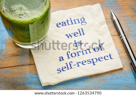 eating well is a form of self-respect - handwriting on a napkin with a glass of fresh, green, vegetable juice