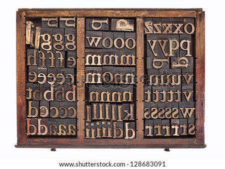 letterpress wood type printing blocks in old typesetter drawer isolated on white