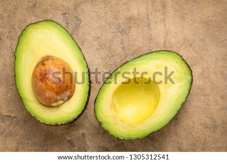 cut avocado fruit against buckskin amate bark paper with a copy space