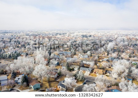 hazy and frosty winter morning over city of Fort Collins and foothills of Rocky Mountains in Colorado, aerial view