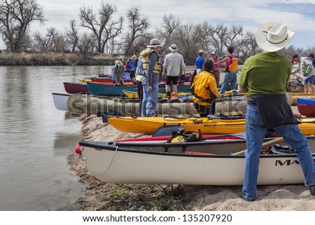 SOUTH PLATTE RIVER, EVANS, COLORADO - APRIL 6: Preparing kayaks and canoes for a launch during Annual All Club Paddle on April 6, 2013, a popular season opening paddling trip in northern Colorado.