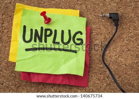 unplug  - lifestyle or information overload concept - handwriting on colorful sticky notes