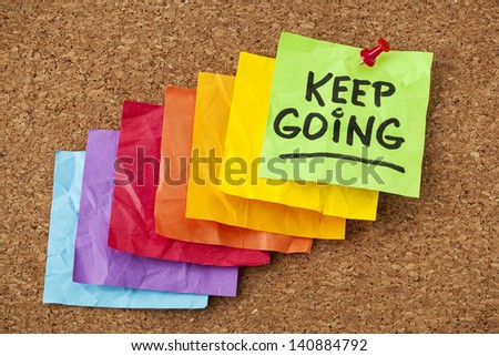 keep going - motivation or determination concept - handwriting on colorful sticky notes