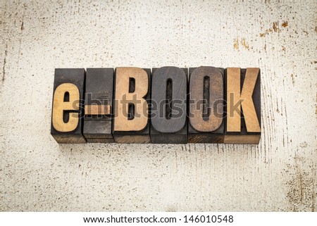 e-book  word in vintage letterpress wood type on a grunge painted barn wood background