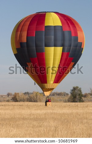 colorful hot air balloon just landed on a field in eastern Colorado