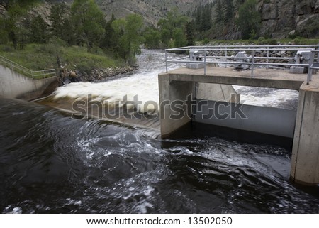water diversion dam on the Cache la Poudre River in Colorado with a  springtime flow