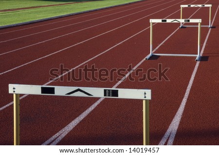 red running tracks with three hurdles set up for training