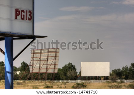 Drive in movie theater with two screens and PG13 film rating sign somewhere in the southwest. HDR image. Copy space.