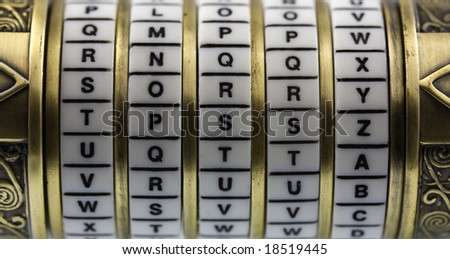sorry word set up as a password to combination puzzle box (cryptex) with rings of letters; selective focus