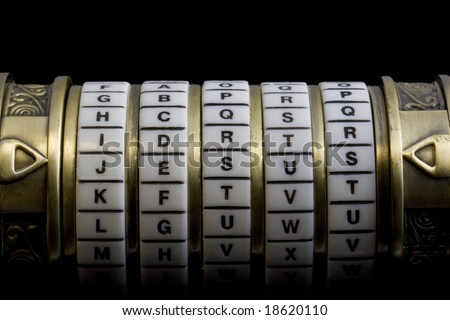 Jesus word set up as a password to combination puzzle box (cryptex) with rings of letters; black background