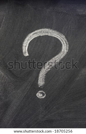 question mark handwritten with a white chalk on on a blackboard