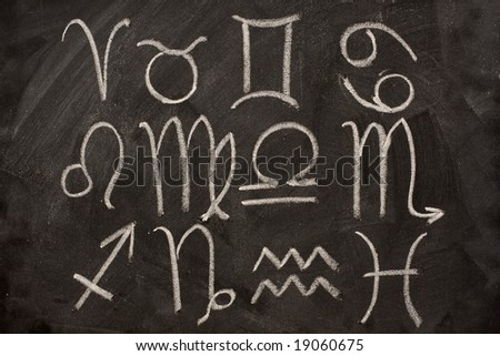 western zodiac symbols (Aries, Taurus, Gemini, Cancer, Leo, Virgo, Libra, Scorpio, Sagittarius, Capricorn, Aquarius, Pisces) handwritten with white chalk on blackboard