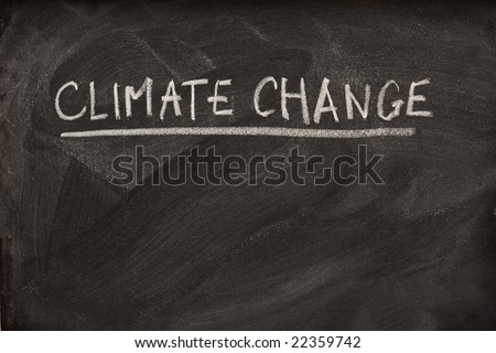 climate change handwritten with white chalk as a title or subject on blackboard