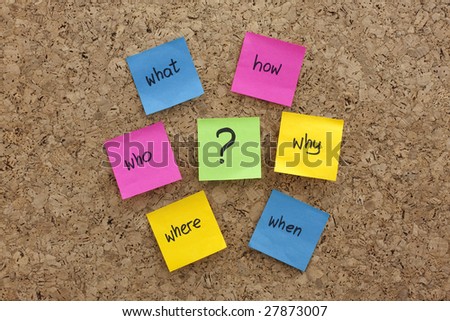 a simple mind map with questions (what, when, where, why, how, who)  to solve a problem posted with colorful sticky notes on cork board