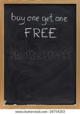 buy one get one free offer - discount sale advertisement handwritten with white chalk on blackboard, copy space below