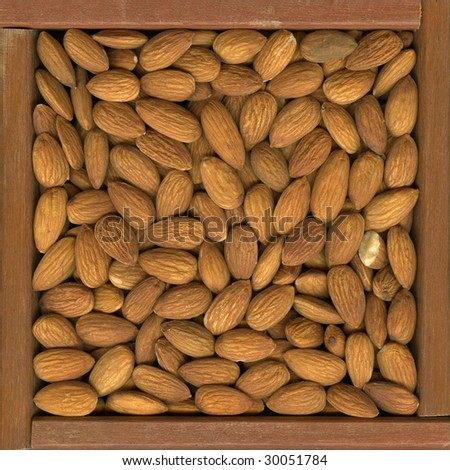 shelled almond nuts in a rustic wooden box or frame