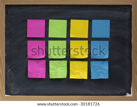 blank, colorful, smooth and crumpled, sticky notes on blackboard with white chalk smudges