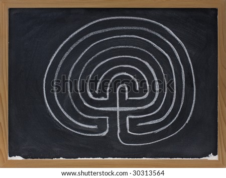 a classical seven ring labyrinth with dead end in the center sketched with white chalk on blackboard
