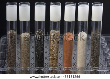 science abstract - glass testing tubes with different sand samples collected from beaches and deserts of western USA and Hawaii
