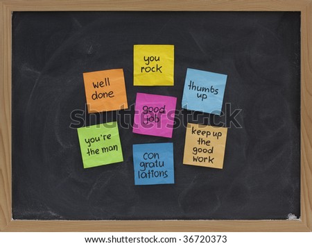 good job, well done, your rock, congratulations and other compliments - colorful sticky notes on blackboard with white chalk smudges
