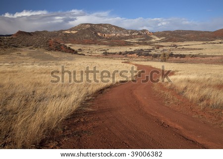 windy road in Red Mountain Open Space in northern Colorado (Larimer County), fall scenery with dry grass moved by wind
