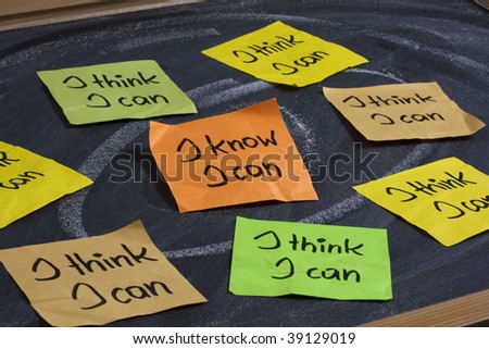 I know I can - self confidence and motivational concept, color sticky notes on blackboard with white chalk smudges, focus on central orange, note