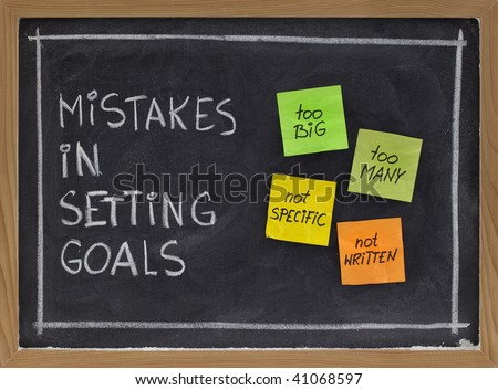 common mistakes in setting goals (too many, too big, not specific, not written) - concept presented with sticky notes and white chalk handwriting on blackboard