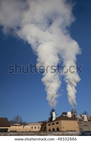two smoke and steam plumes from a small heating plant on cold winter mornings at Colorado State University campus, Fort Collins