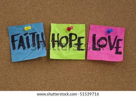 spiritual reminder or metaphysical concept - faith, hope and love handwritten on colorful notes and posted on cork bulletin board