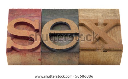 sex word in vintage wooden letterpress printing blocks, stained by color inks, isolated on white