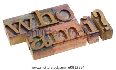 Who am I - a philosophical question spelled in vintage wooden letterpress printing blocks, isolated on white