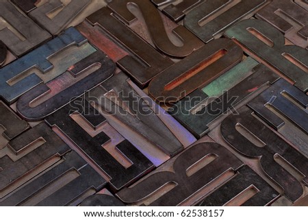 background of antique wooden letterpress printing blocks stained by color inks