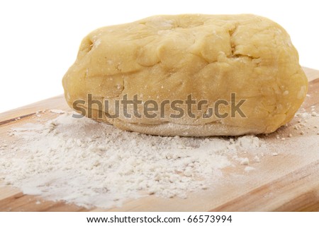 a ball of dough kneaded for a cake on wooden board with wheat flour, isolated on white