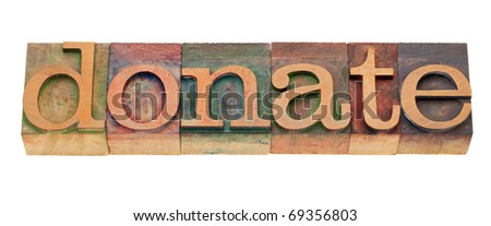 donate - word in vintage wooden letterpress printing blocks, stained by color inks, isolated on white