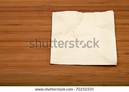 beige cocktail napkin on wooden (Bamboo) table