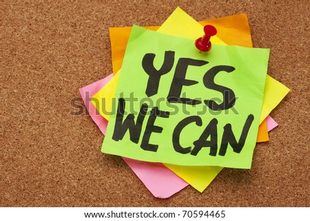 yes we can - motivational slogan on a stack of sticky notes posted on cork bulletin board