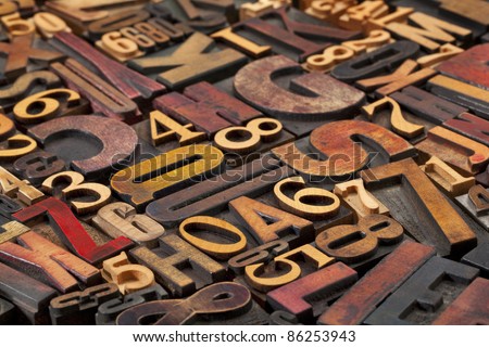 random letters and numbers in antique wood letterpress printing blocks of various size and style