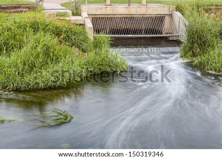 Processed and cleaned sewage flowing out from water reclamation facility to a river