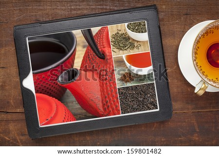 reviewing pictures of tea on a digital tablet, a grunge wood background with a cup of hot tea