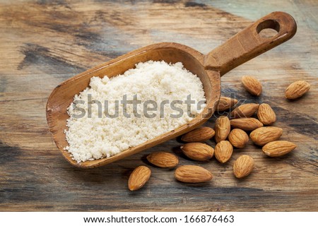Almond Flour High In Protein, Low In Carbohydrates, Low In Sugars And Gluten Free - A Rustic Wooden Scoop On Grained Wood Background