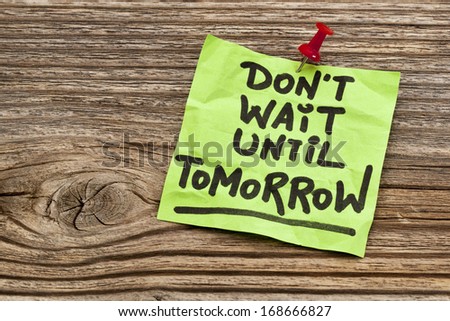 do not wait until tomorrow - motivational reminder - handwriting on sticky note against grained wood