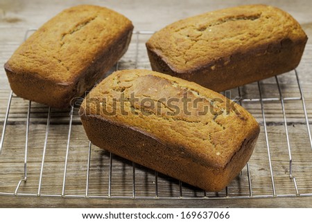 three loafs of freshly baked gluten free bread prepared with coconut and almond flour, flaxseed meal with sesame seeds