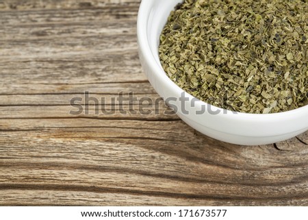 a bowl of sea lettuce seaweed against grained wood with copy space