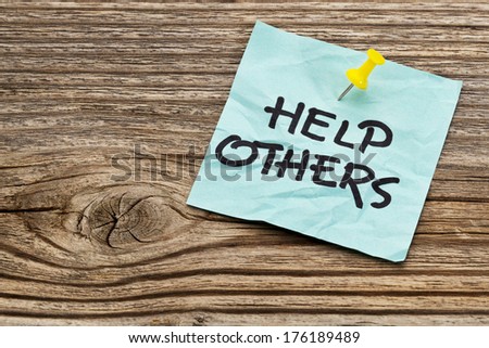help others  reminder note against grained weathered wood