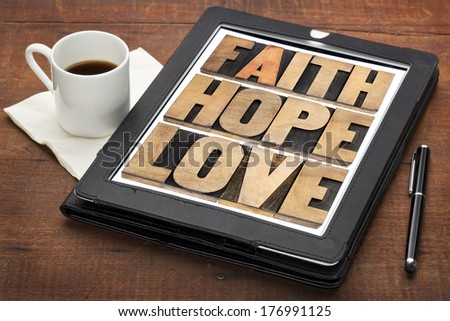 faith, hope and love - a collage of words in vintage letterpress wood type on a digital tablet with a cup of coffee