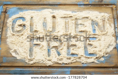 gluten free words written in coconut flour on a wooden board