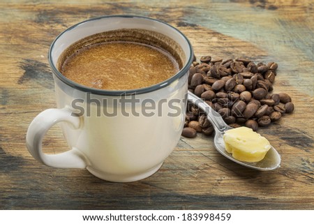 a cup of fresh fatty coffee with butter and coconut oil - ketogenic diet concept - stock photo